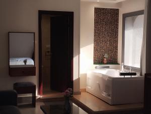 a bathroom with a sink and a mirror and a bed at Zahira Pyramids View in Cairo