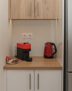 a red appliance sitting on a counter in a kitchen at Luxury penthouse near Acropolis in Athens