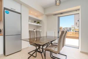 a kitchen with a dining room table and chairs at Luxury penthouse near Acropolis in Athens