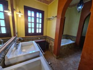 a bathroom with a large sink and a tub at Andalusische Villa in Mairena del Aljarafe +22 photos