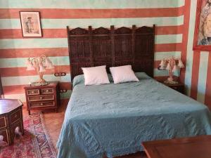 - une chambre avec un lit, 2 tables de nuit et 2 lampes dans l'établissement Andalusische Villa, à Mairena del Aljarafe