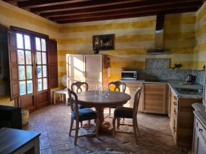 a kitchen with a table and chairs and a refrigerator at Andalusische Villa in Mairena del Aljarafe