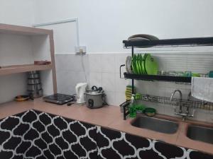 a kitchen with a sink and a counter top at DIAMOND HOMESTAY in Kuala Kangsar