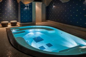 a jacuzzi tub in a room with blue lighting at Hotel Number Nine in Florence