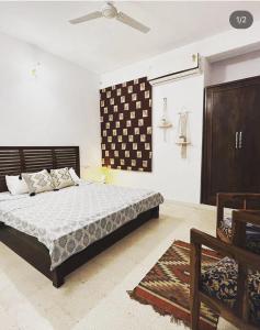 a bedroom with a bed and a ceiling fan at Solanki farms & Pool Villa garden fully private in Jaipur