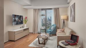 a living room with a couch and a table at Oakwood Makati Avenue in Manila