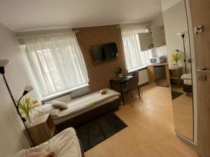 a living room with a bed in a room at BROWARNA apartamenty in Elblag