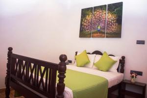 a bedroom with a bed with a firework painting on the wall at B&B Shenal Villa Kosgoda in Kosgoda