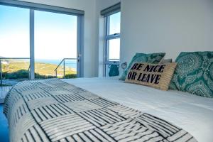 a bedroom with a bed with a be nice or have pillow at Ocean View - The Unit in Knysna