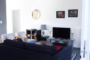 a living room with a couch and a tv at Ocean View - The Unit in Knysna