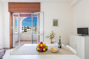 a living room with a table with fruit on it at Residence Kalura by BarbarHouse in Porto Cesareo