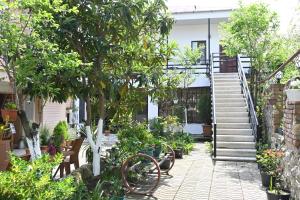 a garden with a staircase and trees and plants at JERUSALEM merkaz Hotel Kutaisi in Kutaisi