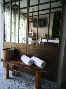 two towels sitting on a bench in front of a mirror at V&Spa 2 chambres d'hôtes avec Spa privatif dont une avec un Sauna in Saint-Martin-Boulogne +39 photos