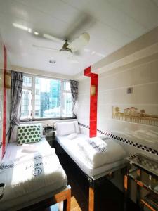 Postel nebo postele na pokoji v ubytování New Peking Guest House