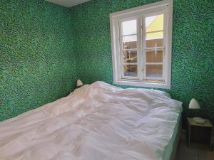 Postel nebo postele na pokoji v ubytování Tinghus Flat