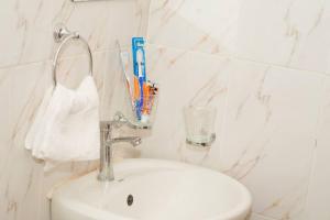 baño con lavabo y cepillo de dientes en Adeti Homestay, en Ruiru