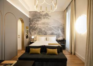 a bedroom with a bed and a chandelier at Elizabeth Unique Hotel | a Member of Design Hotels™ in Rome