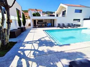 una villa con piscina di fronte a una casa di Casa do Salgueiral Douro a Peso da Régua