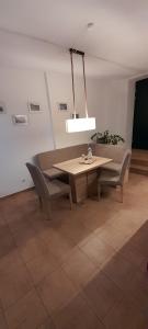 a dining room with a table and two chairs at Apartment Am Markt 4 in Bad Gottleuba