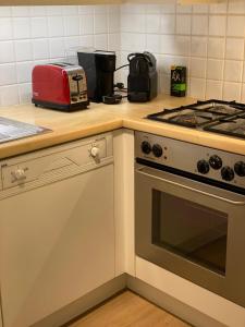 a kitchen with a stove and a toaster on a counter at Tof en ruim appartement in Heist-Aan-Zee! in Knokke-Heist