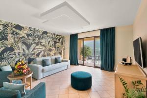 ein Wohnzimmer mit Couch und Fernseher in der Unterkunft Park Hotel Argento in Levanto