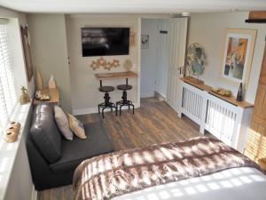 a living room with a couch and a table at Good stay at 91 in Silsden