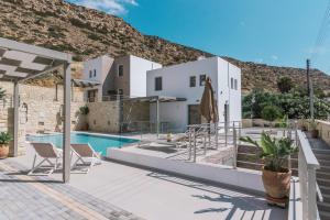 a villa with a swimming pool and a mountain at Matala Prime Villas in Matala