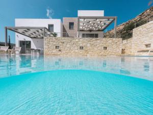 a swimming pool in front of a villa at Matala Prime Villas in Matala