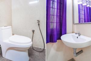 a bathroom with a toilet and a sink at FabExpress UV Residency in Irugūr