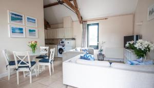 a living room with a couch and a table at Corner Cottage in Shaftesbury