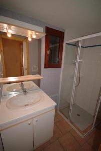 a bathroom with a sink and a shower at Camping Cascade Aveyron in Saint-Rome-de-Tarn +45 photos