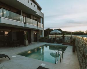 a swimming pool in front of a house at CHE BELLO NATURE in Preveza