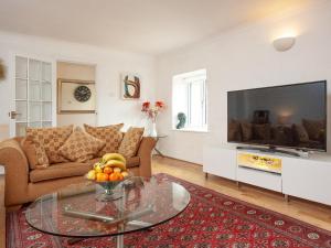 a living room with a large flat screen tv at Hayden Farm in Culmstock