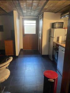 a small room with a kitchen with a door at Studio 29 m2 proche La Défense et Arena in Nanterre