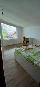 1 dormitorio con 1 cama, 1 silla y 1 ventana en Goritsa holiday - Karadere beach, en Goritsa