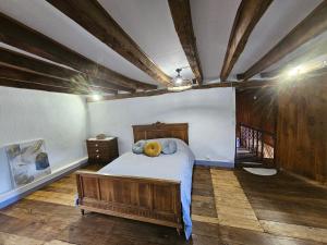 a bedroom with a bed with a teddy bear on it at La villa aux volets bleus in Saint-Étienne-de-Fursac