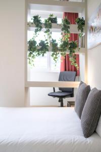 um quarto com uma cama, uma mesa e uma janela em Beau studio dans le Centre de Bruxelles em Bruxelas