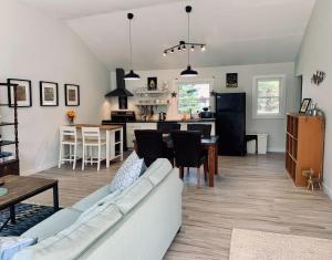 a living room and kitchen with a couch and a table at Serene Cottage in Halifax