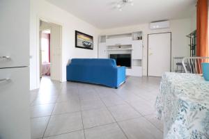 uma sala de estar com um sofá azul e uma mesa em Casa di Lulù (lago e Spiaggia) em Manerba del Garda