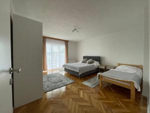 two beds in a room with wooden floors at BORIĆI in Bihać