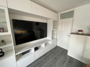 a living room with a large flat screen tv at Cosy 2-Bed House in Ancoats Manchester! in Manchester