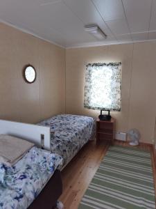 a bedroom with a bed and a window and a rug at Riverside Restplace in Tornio