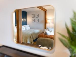 a reflection of a bedroom in a mirror at Askival Studio - Ukc6563 in Mallaig