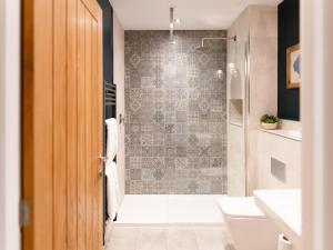 a bathroom with a shower and a toilet and a sink at Askival Studio - Ukc6563 in Mallaig