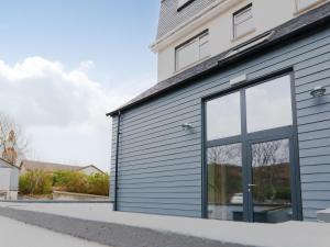 a gray garage with a large glass door at Askival Studio - Ukc6563 in Mallaig