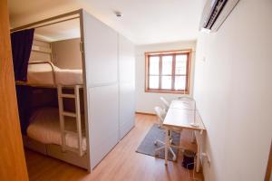 a small room with a desk and bunk beds at Lindo Vale 412 in Porto +25 photos