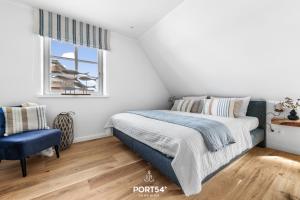 Postel nebo postele na pokoji v ubytování Ferienhaus Reetlodge auf den Schleiterrassen Kappeln