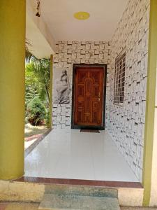 a entrance to a house with a wooden door at Vrundavan in Panchgani