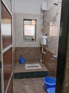 a bathroom with a toilet in the corner of a room at Vrundavan in Panchgani