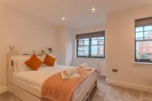 a bedroom with a bed with two towels on it at Stylish Westgate-on-sea Haven Near Beach in Margate